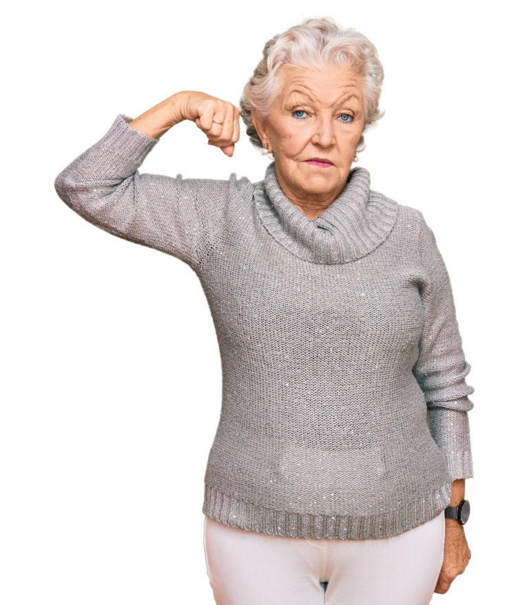 Eine ältere Frau, ernster Gesichtsausdruck, hebt ihren Arm und zeigt ihre Muskeln. Sie möchte damit verdeutlichen, dass Sport auch im hohen Alter eine bedeutende Rolle spielt.